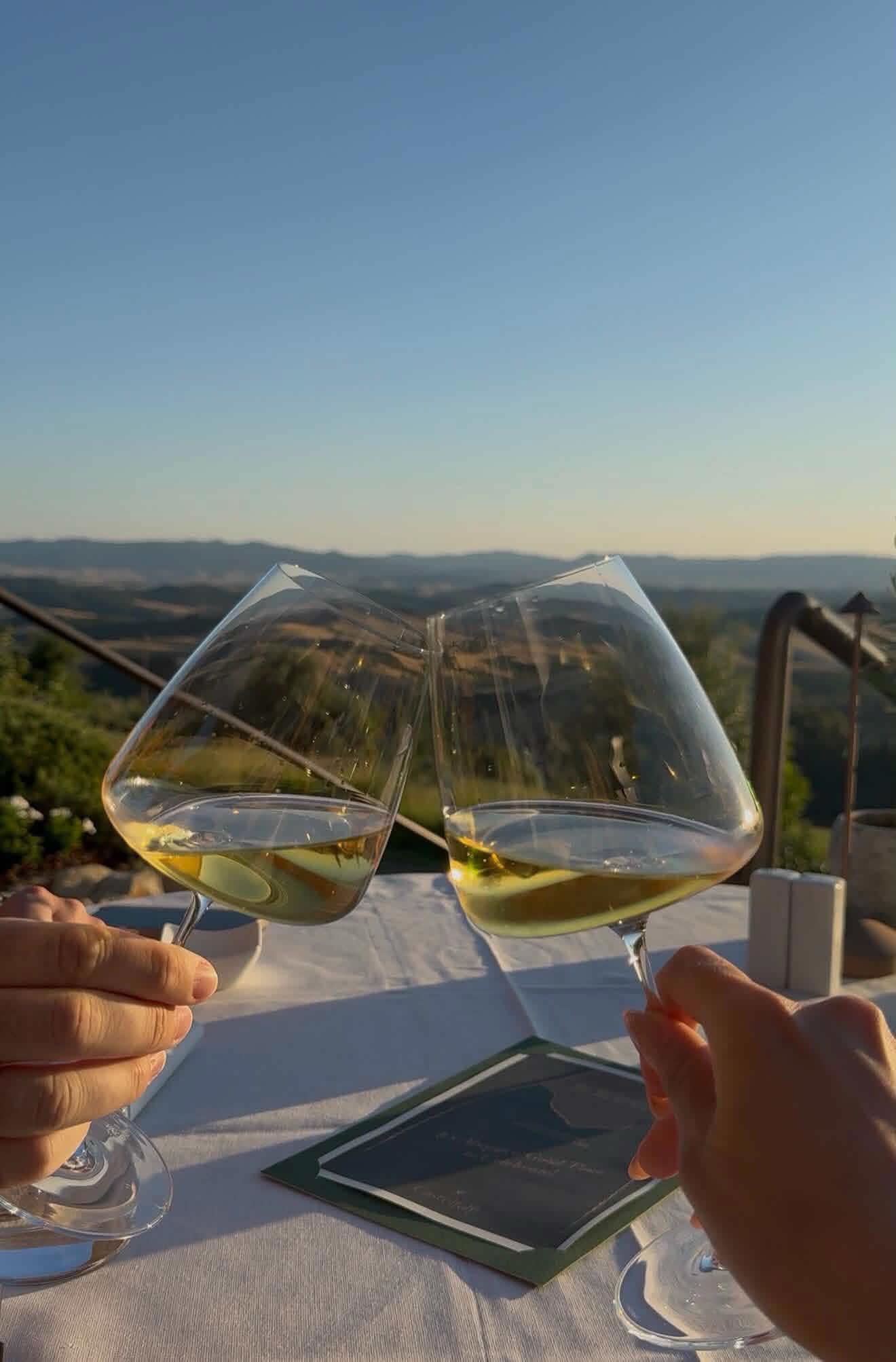 Two glasses of wine at sunset over the Tuscan hills